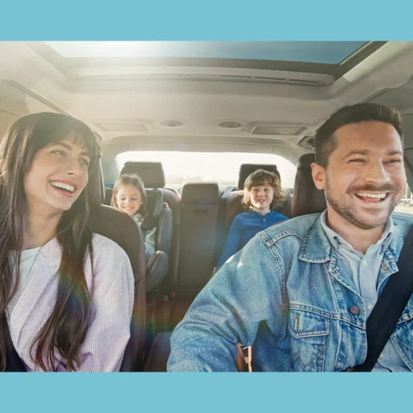 A happy family traveling in a car.