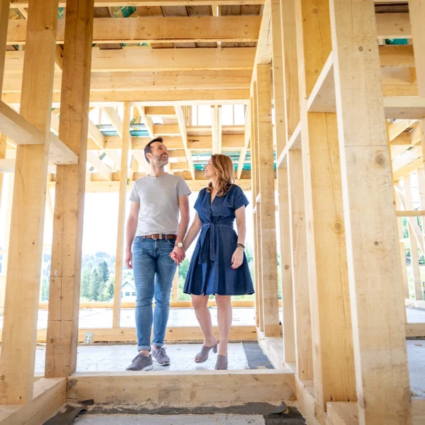 Happy couple touring their new home while it