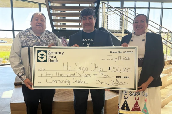 He Sapa Otipi receiving a check in support of the Indigenous-led Community Center in Rapid City.